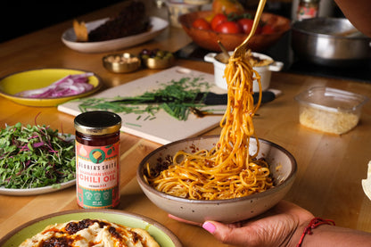 A plate of Gloria's Shito Spicy Chili Oil Pasta, showcasing a mouthwatering dish of pasta drizzled with Gloria's spicy chili oil shito sauce. Product photography Ghanaian chili oil.