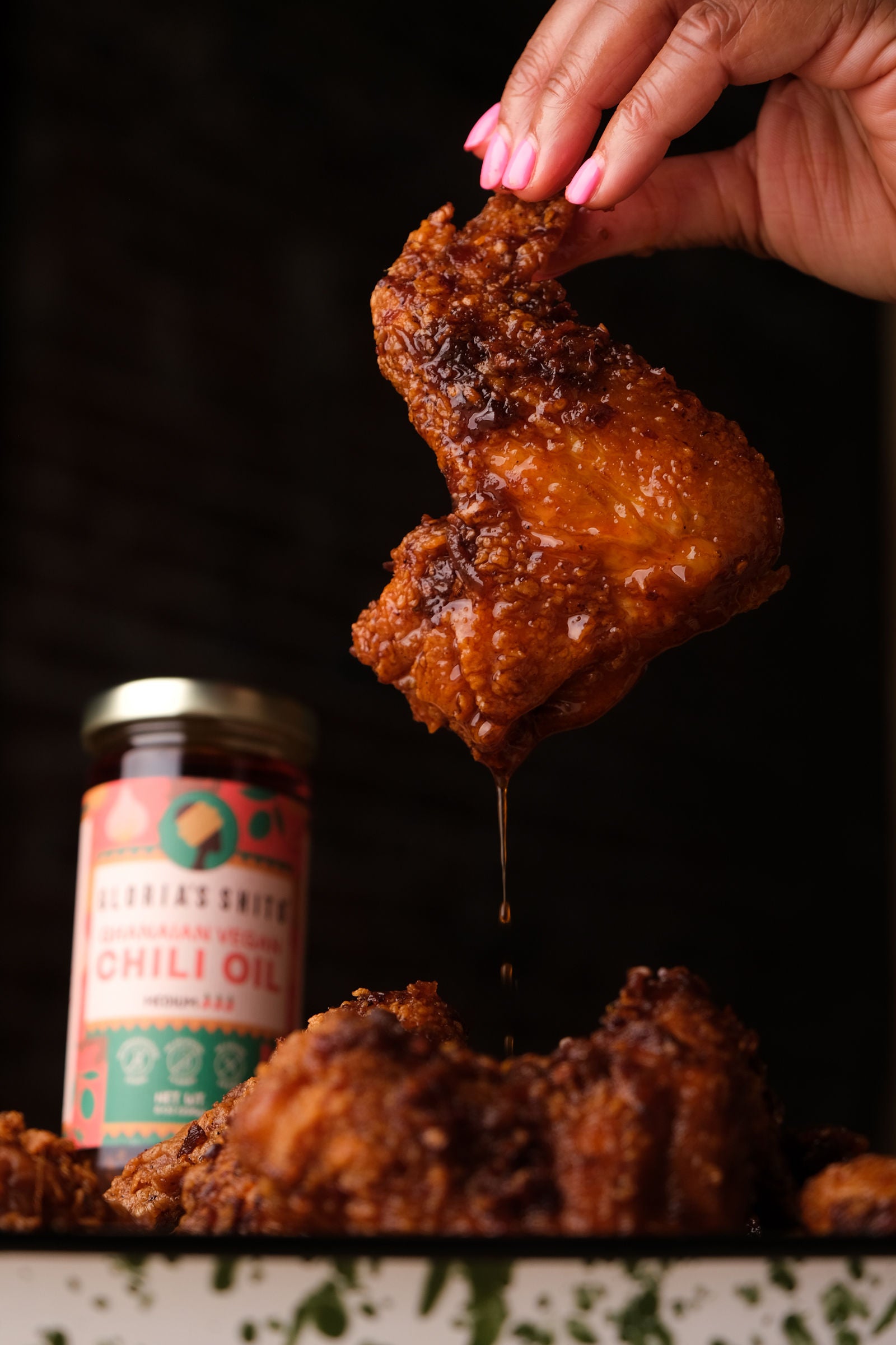 Crispy Fried Chicken Wings, dipped in chili oil, Ghana shito.